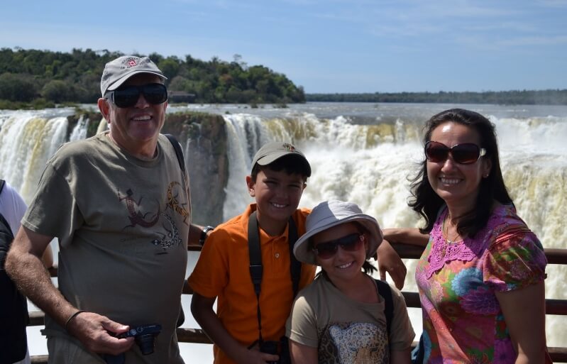 Karen Back with her husband and two children stood in front of a waterfall